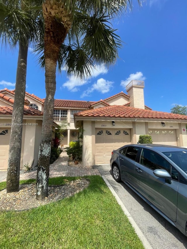 10803 Cypress Glen Dr Unit 10803, Coral Springs, FL 33071 - mediterranean / spanish house with a garage, stucco siding, a chimney, and a tile roof