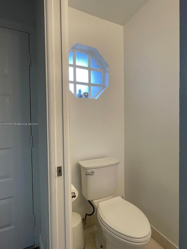 10803 Cypress Glen Dr Unit 10803, Coral Springs, FL 33071 - bathroom featuring baseboards, toilet, and tile patterned flooring