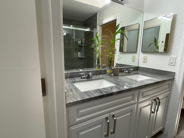 10803 Cypress Glen Dr Unit 10803, Coral Springs, FL 33071 - bathroom with double vanity, a textured wall, a stall shower, and a textured ceiling