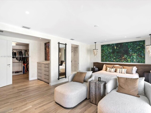 2371 Bayview Ln, North Miami, FL 33181 - bedroom with light wood finished floors, a walk in closet, recessed lighting, a closet, and baseboards