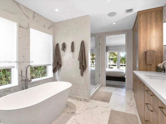 2371 Bayview Ln, North Miami, FL 33181 - full bathroom with vanity, marble tiled flooring, a soaking tub, a stall shower, and recessed lighting