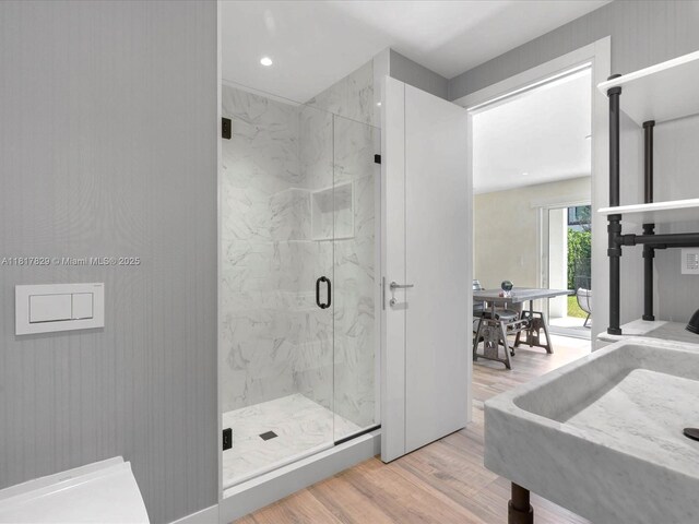 2371 Bayview Ln, North Miami, FL 33181 - full bath with wood finished floors, a marble finish shower, and recessed lighting