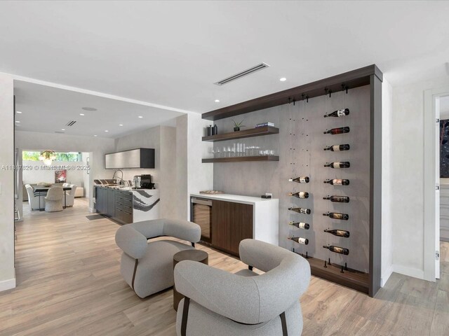 2371 Bayview Ln, North Miami, FL 33181 - wine room featuring light wood-style floors, bar area, and baseboards