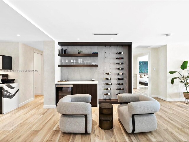 2371 Bayview Ln, North Miami, FL 33181 - living area featuring a bar, light wood-style flooring, baseboards, and recessed lighting