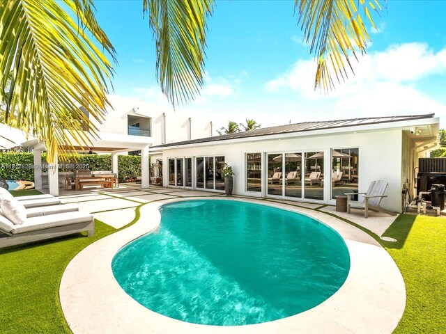 2371 Bayview Ln, North Miami, FL 33181 - outdoor pool featuring an outdoor kitchen, a patio area, and a ceiling fan