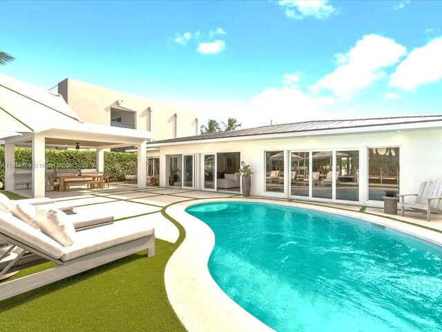 2371 Bayview Ln, North Miami, FL 33181 - outdoor pool with a patio, an outdoor living space, and an outdoor kitchen