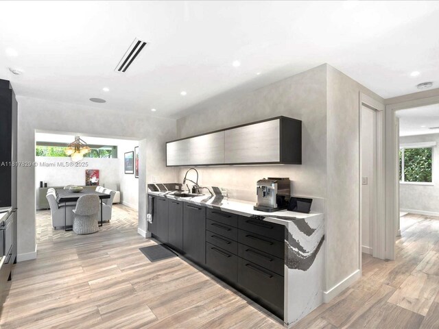 2371 Bayview Ln, North Miami, FL 33181 - kitchen with a sink, light wood-style floors, light countertops, recessed lighting, and baseboards