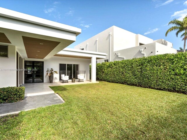 2371 Bayview Ln, North Miami, FL 33181 - view of grassy yard with a patio area