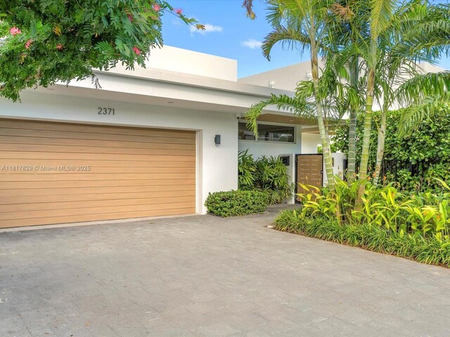 2371 Bayview Ln, North Miami, FL 33181 - view of front of property featuring stucco siding and driveway
