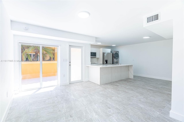 13900 SW 65th Ter Unit 9, Miami, FL 33183 - unfurnished living room featuring baseboards, washer / dryer, and recessed lighting