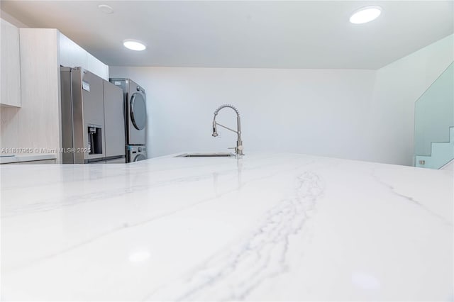 13900 SW 65th Ter Unit 9, Miami, FL 33183 - detailed view of stacked washer / dryer, stainless steel fridge with ice dispenser, and a sink
