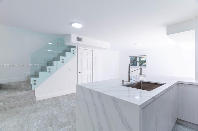 13900 SW 65th Ter Unit 9, Miami, FL 33183 - kitchen with a sink, light stone counters, light marble finish floors, modern cabinets, and baseboards