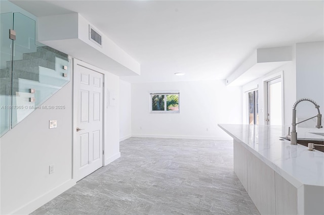 13900 SW 65th Ter Unit 9, Miami, FL 33183 - unfurnished living room with a sink, stairs, and baseboards