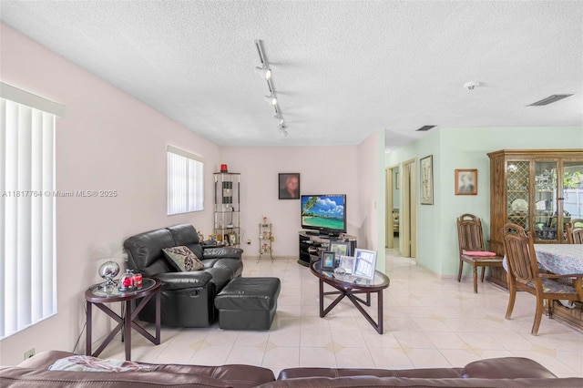 10845 SW 26th Ter, Miami, FL 33165 - living area with track lighting, a textured ceiling, and light tile patterned flooring