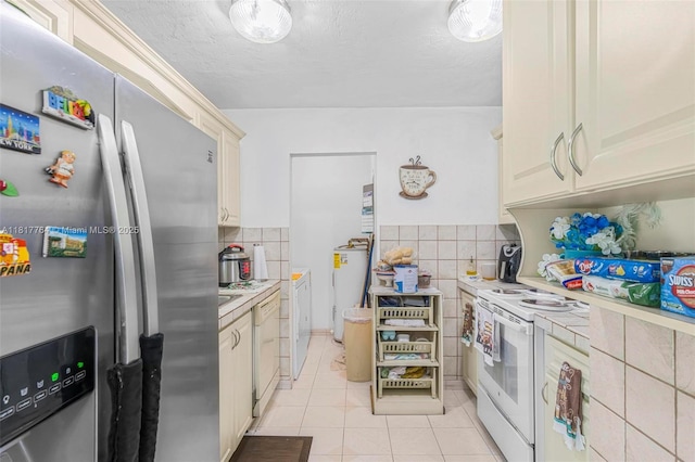 10845 SW 26th Ter, Miami, FL 33165 - kitchen with white appliances, light tile patterned floors, light countertops, tile walls, and water heater