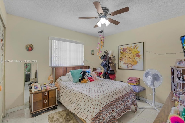 10845 SW 26th Ter, Miami, FL 33165 - bedroom with tile patterned floors, a textured ceiling, ceiling fan, and baseboards