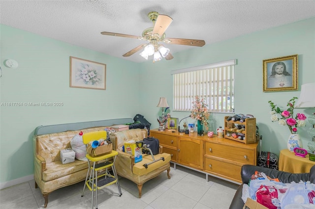 10845 SW 26th Ter, Miami, FL 33165 - bedroom with light tile patterned flooring, a textured ceiling, and a ceiling fan