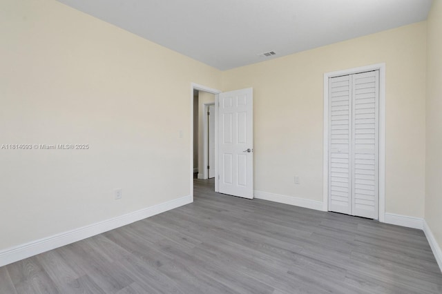 6221 NW 37th Ter, Virginia Gardens, FL 33166 - unfurnished bedroom with wood finished floors and a closet