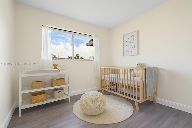 6221 NW 37th Ter, Virginia Gardens, FL 33166 - bedroom featuring wood finished floors and a crib