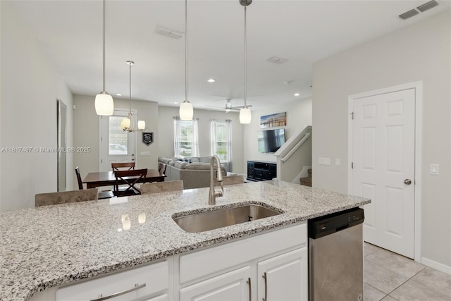 2200 Garden Belle Dr, Clermont, FL 34711 - kitchen with stainless steel dishwasher, a sink, open floor plan, light tile patterned floors, and light stone countertops