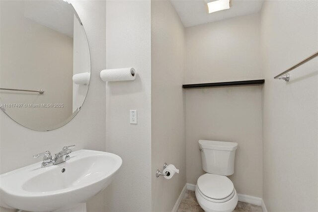 2200 Garden Belle Dr, Clermont, FL 34711 - bathroom with a sink, toilet, and baseboards