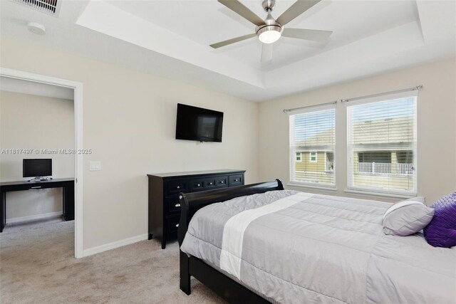 2200 Garden Belle Dr, Clermont, FL 34711 - bedroom with a raised ceiling, light carpet, baseboards, and ceiling fan