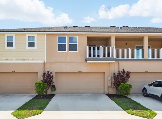 2200 Garden Belle Dr, Clermont, FL 34711 - multi unit property featuring an attached garage, stucco siding, and concrete driveway
