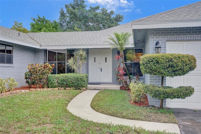 4459 NW 113th Ln, Coral Springs, FL 33065 - entrance to property with a yard, roof with shingles, and brick siding