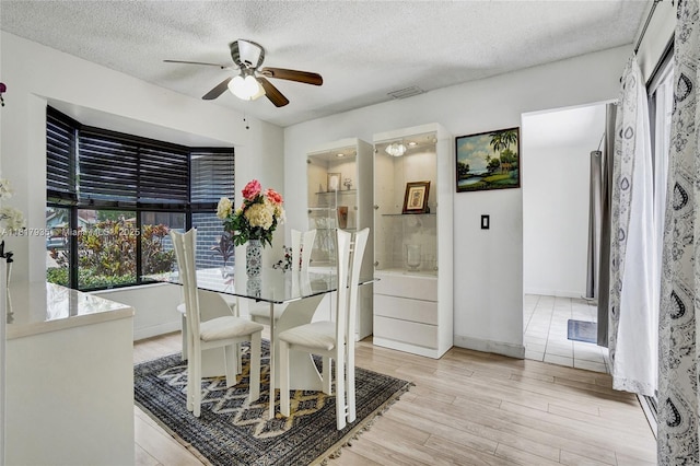 4459 NW 113th Ln, Coral Springs, FL 33065 - dining area with a ceiling fan, light wood-type flooring, a textured ceiling, and baseboards