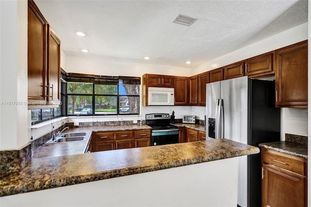 4459 NW 113th Ln, Coral Springs, FL 33065 - kitchen with white microwave, electric range, stainless steel fridge with ice dispenser, a sink, and a peninsula