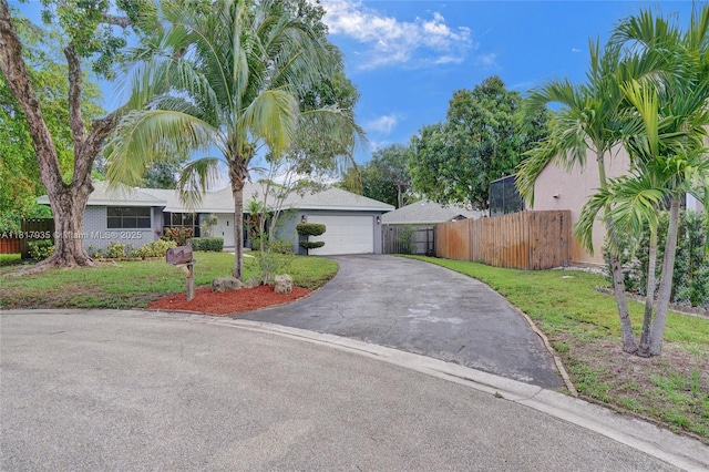 4459 NW 113th Ln, Coral Springs, FL 33065 - view of front of home with asphalt driveway and an attached garage
