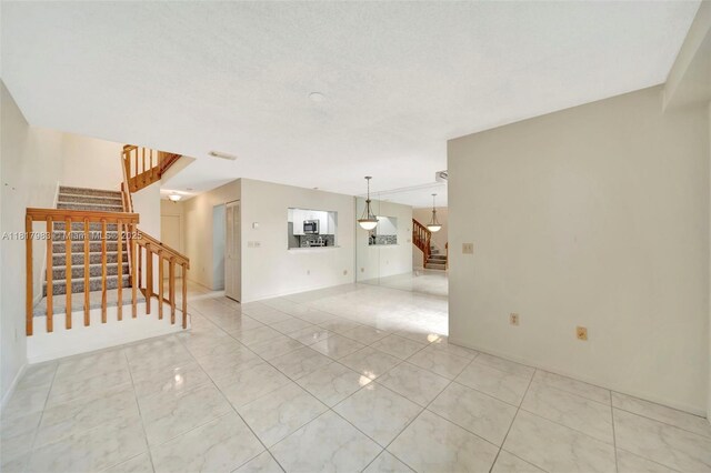 1615 N 14th Ter, Hollywood, FL 33020 - unfurnished living room with stairs and light marble finish flooring