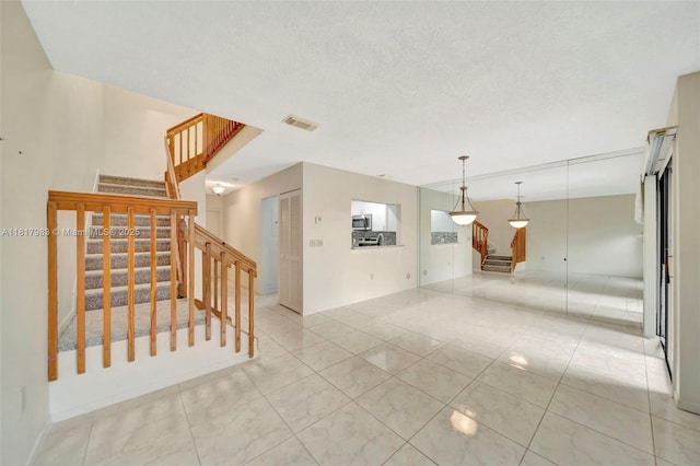 1615 N 14th Ter, Hollywood, FL 33020 - unfurnished room with stairway and light tile patterned floors