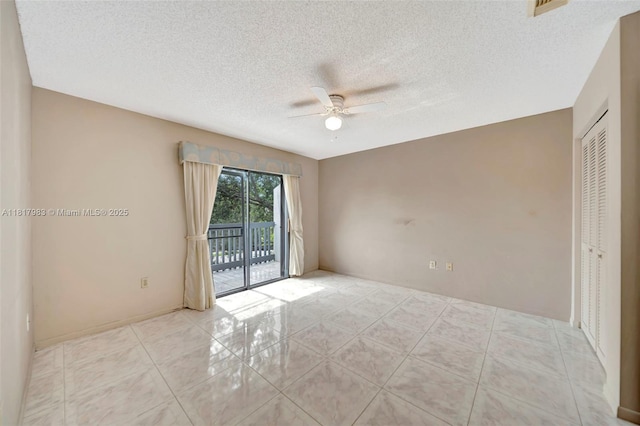 1615 N 14th Ter, Hollywood, FL 33020 - empty room with ceiling fan, tile patterned floors, and a textured ceiling