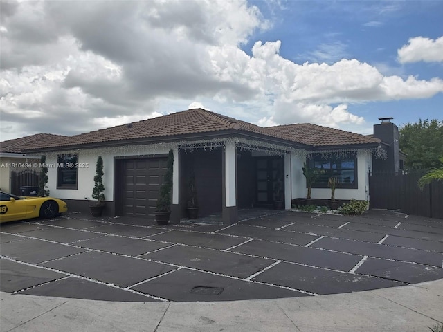 14880 SW 56th Ter, Miami, FL 33193 - view of property exterior with an attached garage, stucco siding, and a tile roof