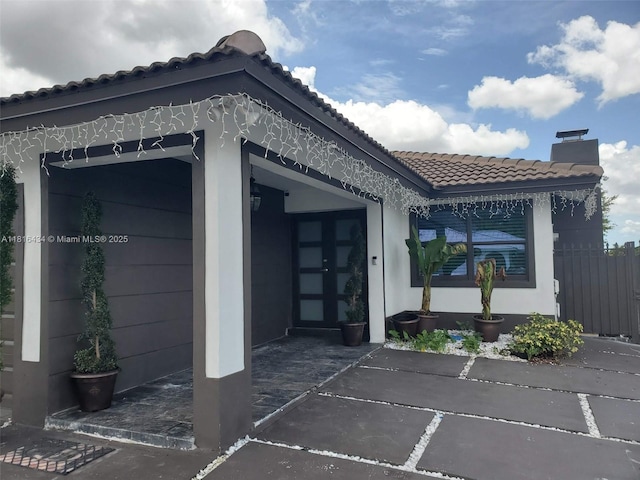 14880 SW 56th Ter, Miami, FL 33193 - view of side of property with a chimney, a tiled roof, and stucco siding