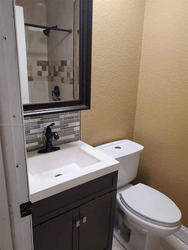 14880 SW 56th Ter, Miami, FL 33193 - bathroom with backsplash, vanity, toilet, and a textured wall