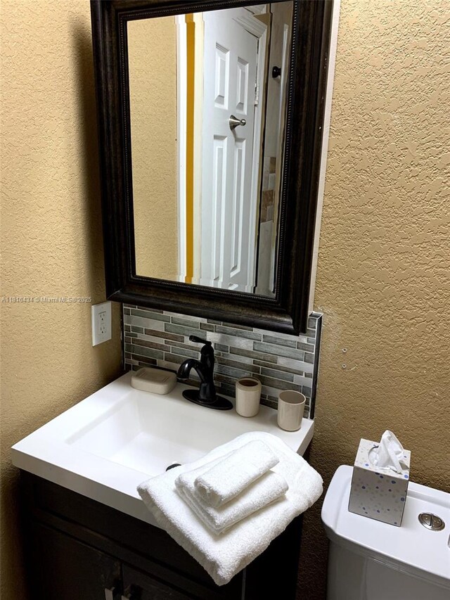 14880 SW 56th Ter, Miami, FL 33193 - bathroom featuring backsplash, a textured wall, vanity, and toilet