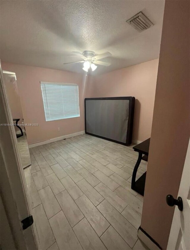 14880 SW 56th Ter, Miami, FL 33193 - empty room featuring a textured ceiling, a ceiling fan, and baseboards