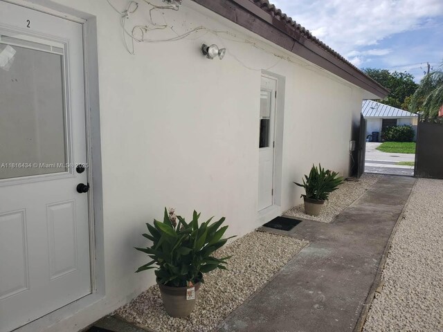 14880 SW 56th Ter, Miami, FL 33193 - doorway to property with stucco siding and a tile roof
