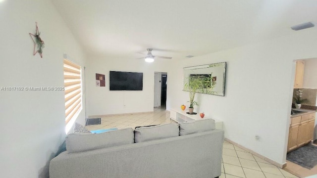 200 W 53rd Ter, Hialeah, FL 33012 - living area with light tile patterned floors, ceiling fan, and baseboards