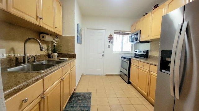200 W 53rd Ter, Hialeah, FL 33012 - kitchen with stainless steel appliances, a sink, light tile patterned floors, and light brown cabinets