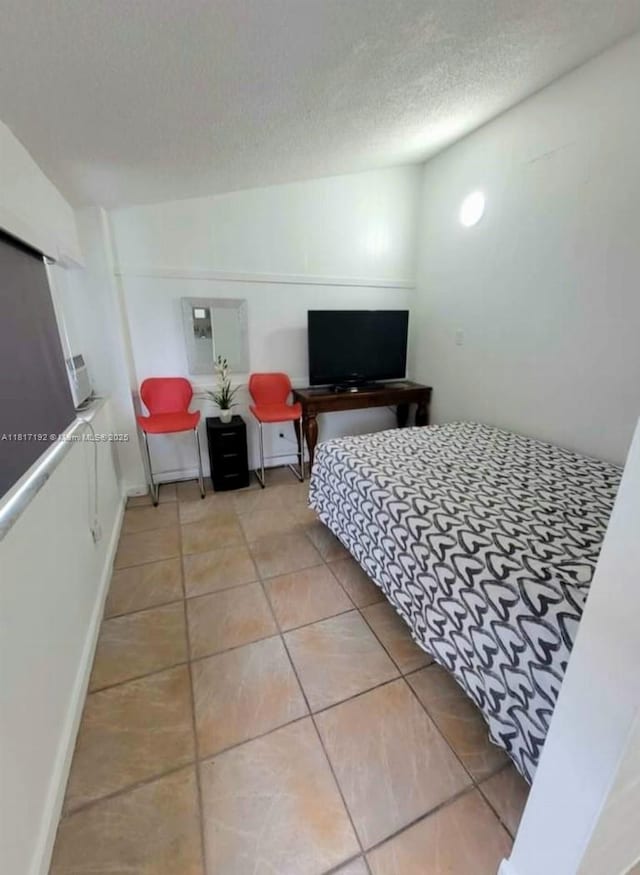 200 W 53rd Ter, Hialeah, FL 33012 - bedroom with tile patterned floors and a textured ceiling