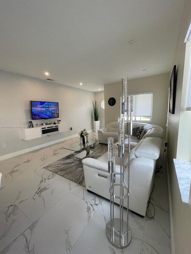 12453 SW 197th Ter, Miami, FL 33177 - living room featuring marble look tiles, recessed lighting, and baseboards