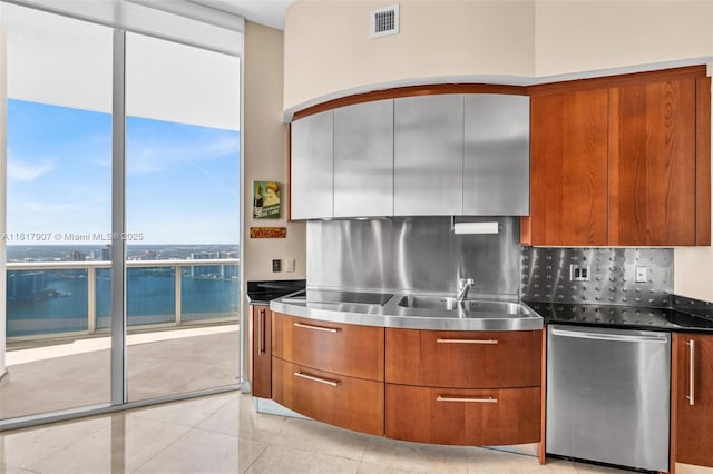 18101 Collins Ave Unit 5401, Sunny Isles Beach, FL 33160 - kitchen with stainless steel countertops, dishwasher, tasteful backsplash, modern cabinets, and brown cabinets