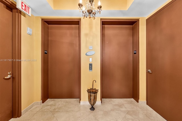 18101 Collins Ave Unit 5401, Sunny Isles Beach, FL 33160 - hall with elevator, a chandelier, baseboards, and light tile patterned flooring
