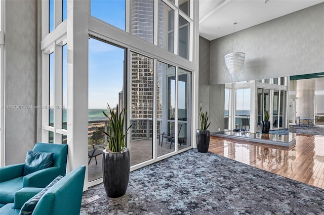 18101 Collins Ave Unit 5401, Sunny Isles Beach, FL 33160 - interior space featuring a high ceiling, healthy amount of natural light, wood finished floors, and a water view
