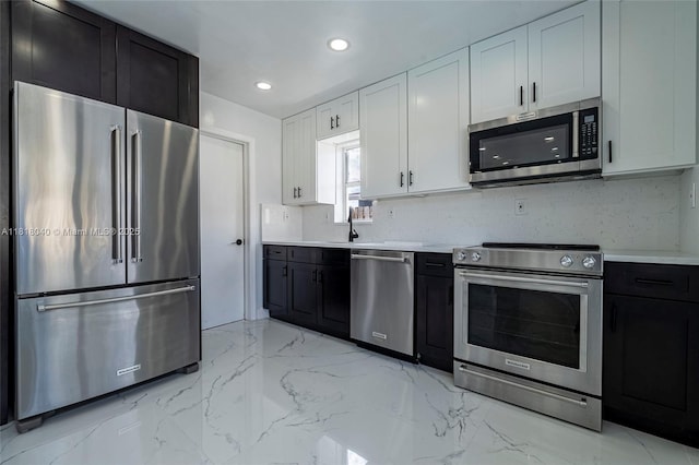 6113 NW 18th St, Margate, FL 33063 - kitchen with stainless steel appliances, light countertops, white cabinetry, dark cabinetry, and recessed lighting