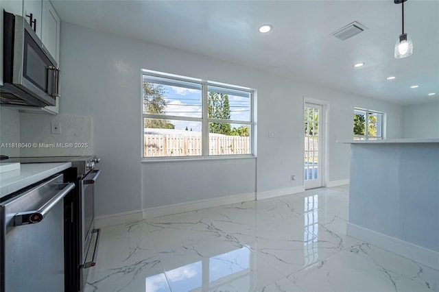 6113 NW 18th St, Margate, FL 33063 - kitchen with appliances with stainless steel finishes, baseboards, recessed lighting, light marble finish floors, and light countertops