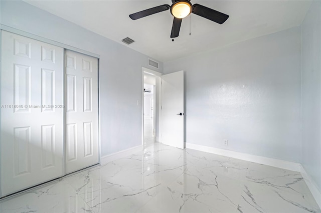 6113 NW 18th St, Margate, FL 33063 - unfurnished bedroom with baseboards, light marble finish floors, a closet, and a ceiling fan